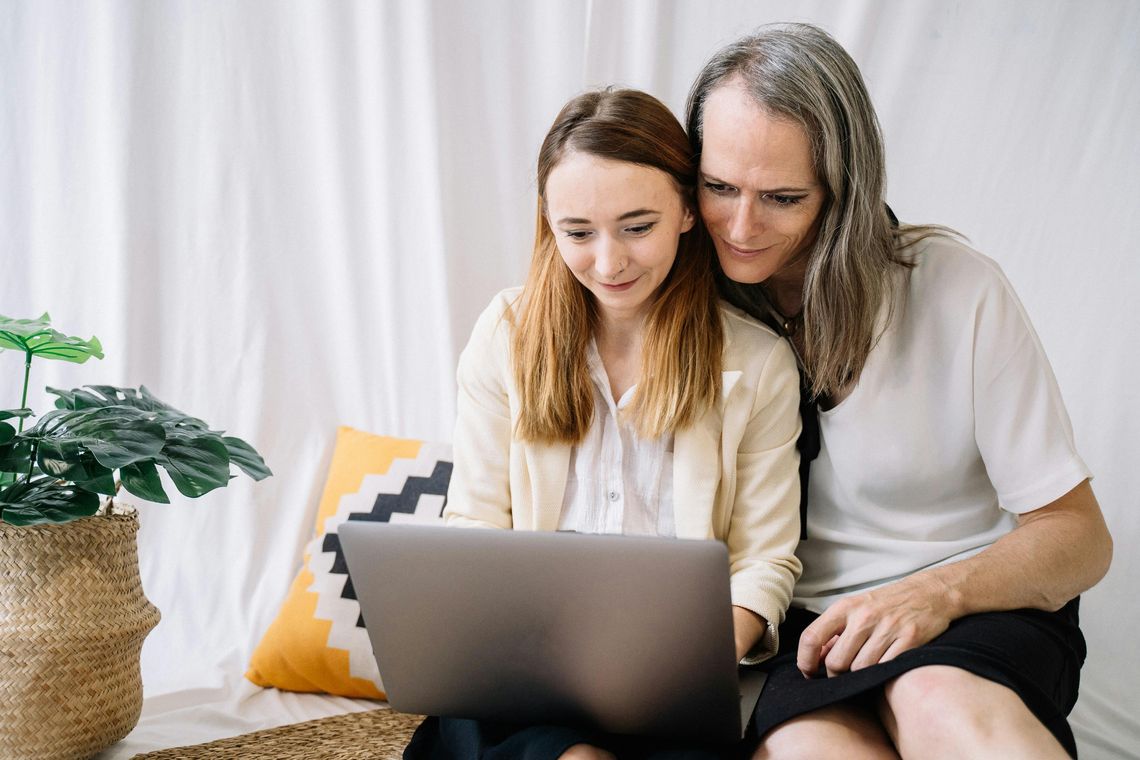 diverse couple looking at laptop