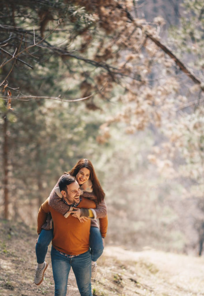 man hiking with woman in a beautiful forest